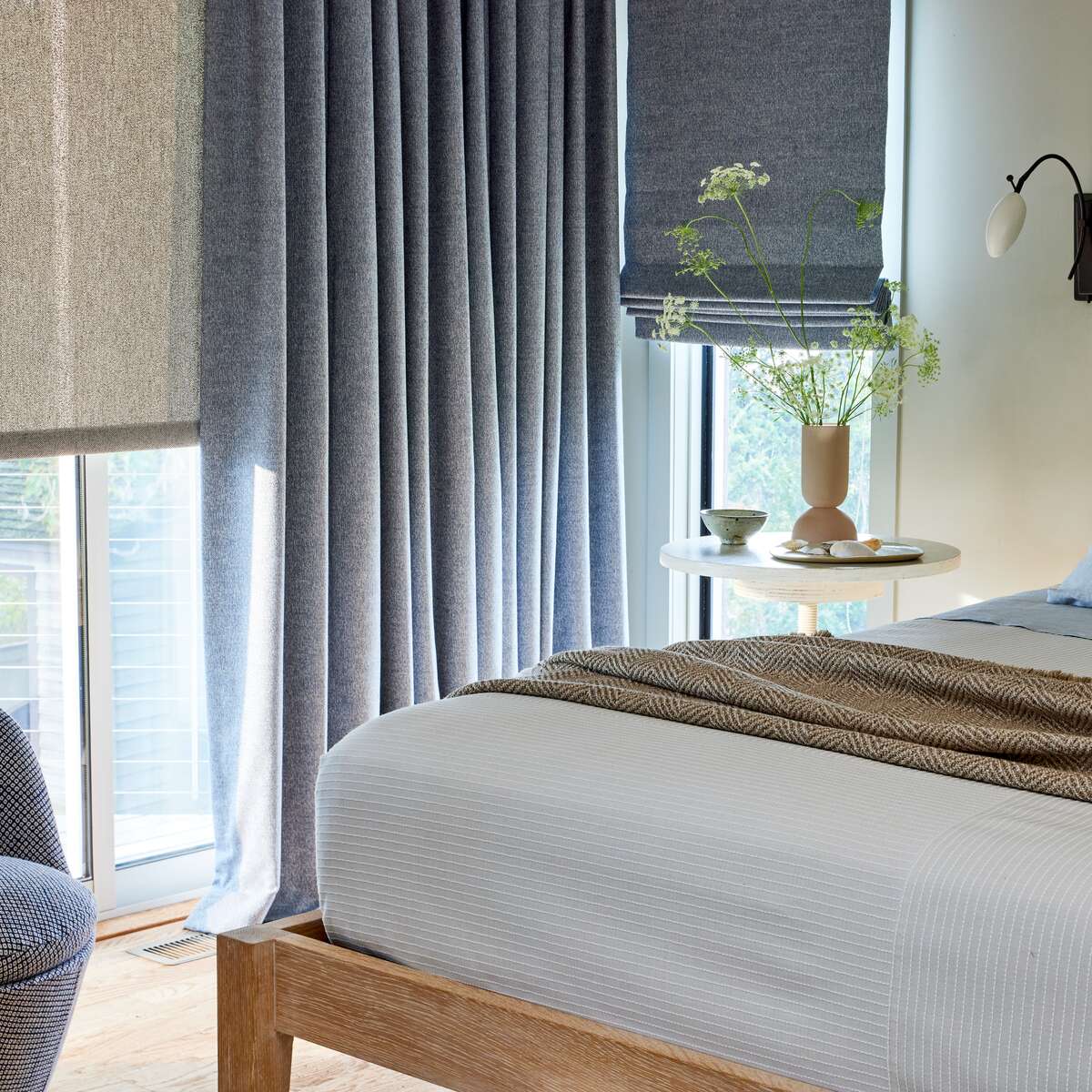 blue sunbrella window treatments in a bedroom