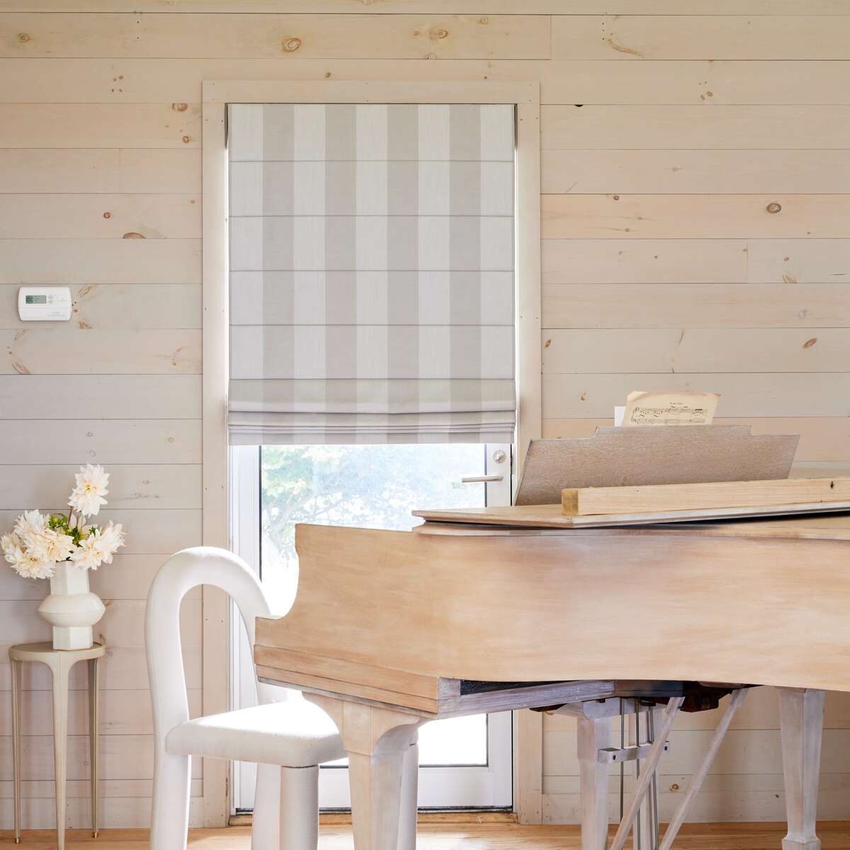 gray sunbrella window treatments in a living room behind a piano