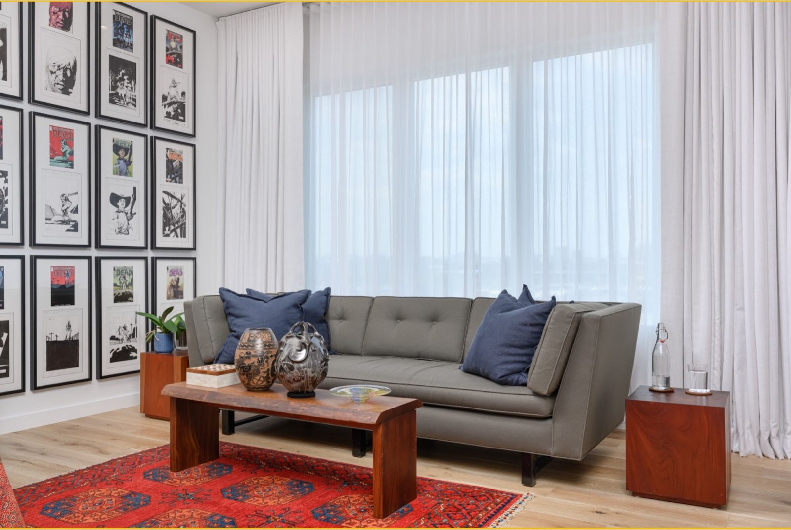 ripplefold drapery over living room window with gray couch